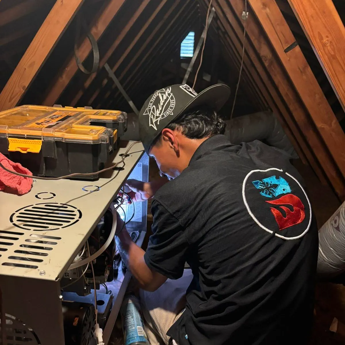 A Barraza technician repairing a furnace in an attic